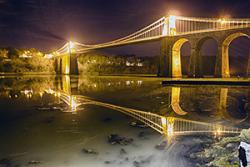 The Menai Suspension Bridge, just one example of night-time illumination along our coastline.