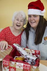 Student nurses at Wrexham Maelor hospital delivering Christmas gifts to patients on  the Bedwen and Onnen long stay rehab wards. Pictured is Ceri Davies delivering a gift to a patient.