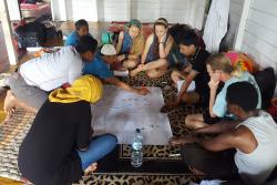 Holding a discussion session with people that had been interviewed on their farms. : © Genevieve Agaba