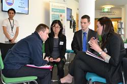 Three of the winning FLUX team -from left: ZhiHong Zhao, Daniel Taylor and Kate Ishwerwood, discsussing with James Johnston from Costain Ltd during one of the competition mentor meetings.