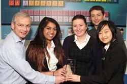 (l-r) Caitlin Pierce, Elin Wynne and Alice Ma, being presented by Dr Mike Becket, head of Bangor University’s School of Chemistry, with their teacher Mark Hannat,  a Bangor University Chemistry graduate.