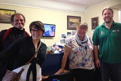 Volunteers, Johanna Illers and Tref Alun meet staff and service users at the Lighthouse Day Centre in Holyhead which received 13 boxes of food donated by Bangor University students.