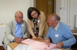 Professor Linton and two workshop attendees in animated discussion.