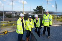 Left- right are Mark McNamee, Managing Director, Cityheart Ltd.; Peter Dodd, Senior Project Manager, Vinci Construction UK Ltd. with Professor John G Hughes, Vice Chancellor conducting the ‘topping out’ and John Roberts, Vinci Construction UK.