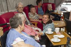 Eluned Morgan, Minister for the Welsh Language, chats with residence of at Cartref Annwyl Fan Care Home.