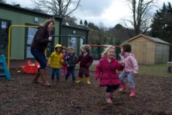 Catherine Sharp with some of the children at the University’s Tir Na n’Og Day Care and Child Research Centre.