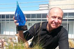 Professor Chris Freeman with his recent award as a Fellow of the Society of Wetland Scientists – recognising him as one of the world’s leading experts on wetlands