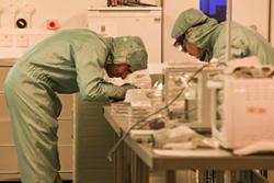 Dr Jeff Kettle and colleague in the ’clean room’  facility, where pv materials are fabricated and tested, at the School of Electronic Engineering. 