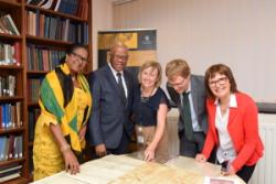 Dr Lola Ramocan, His Excellency Mr Seth George Ramocan, Elen Wyn Simpson, Archivist, Shaun  Evams, Institute for the Study of WEsl Estates (ISWE) and Dr Marian Gwyn, ISWE Research Associate, inspect documents  from the Penrhyn Collection.
