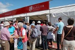 Bangor University's activities on the Maes attract a crowd.