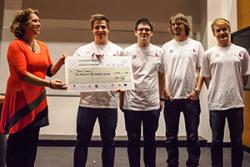 Paola Dyboski-Bryant from Dr Zigs Extraordinary Bubbles presents a cheque to winners, Team Crocus, who are:(l -r) Sam James, Bogdan Pop, Jordan Burns and Rory Robson.