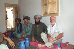 John Witcomce ( right) discussing with farmers in Afghanistan.