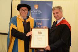 Professor John Ashton (left) receives his Honorary Fellowship from Mr Colin Morrison, the CBI's Deputy Chief Executive & Director of Education