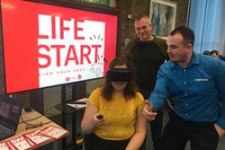 Jenny Light-Hook experiencing VR equipment with Samsung and Virgin representatives.