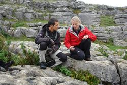 Dr Lynda Yorke explaining to Bear Grylls how the rock beneath them was formed.