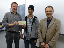 Abdull Mulla with Professor Paul Spencer and Dr Iestyn Pierce receiving his MEng bursary cheque