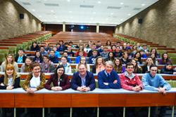 Front row l-r: Victoria Tyler, Ysgol John Bright; Rhian Jones, PGCE student, Samantha Durbin, Royal Institution,  Gordon Malcolm, Magnox Wylfa Site, Chris Wensley, School of Computer Science, Geraint Simpson, Ysgol Uwchradd Caergybi, Geraint Rowlands,: PGCE student, and behind them, the current Maths Masterclass participants.