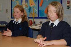 Ella Manfredi  and Ellidy Cole of Ysgol Pen y Bryn practicing Paws B in their classroom.