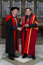 Prof Oliver Turnbull (left) presenting Dr Kuan with his Teaching Fellowship.