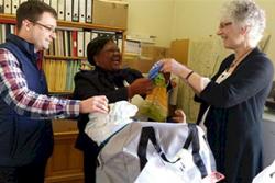 Aaron Pritchard, Research Officer at the College of Health & Behavioural Sciences, Likeleli Nkhatpetla and Kathrin Thomas (BCUHB) inspecting a medical training model.