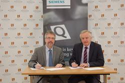 Dr Fraser Logue, Vice President Operations and Managing Director at Siemens Healthcare Diagnostics (left) and Professor John G Hughes, Vice-Chancellor of Bangor University sign the Memorandum.