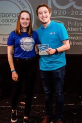 Becca Martin presents choirs conductor Steffan Daffyd with an Award.