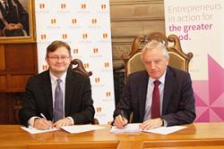 Andrew Bacon, Chief Executive of Enactus UK and Professor John G Hughes, Bangor University Vice-Chancellor sign the agreement.