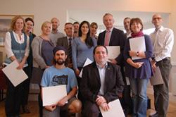 Bangor University staff and postgraduates with their certificates.