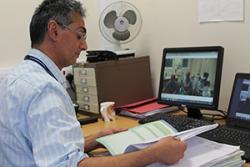 Dr Salah Elghenzai, Lead Care Of The Elderly Consultant Physician, BCUHB, carries out an audio-visual appointment as part of the CARTREF project, which has been highly commended at a national healthcare award.