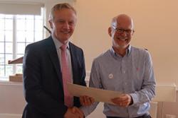 Elwyn Hughes (right) presents the Vice-chancellor with his certificate.