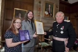 Helen Munro, Student Volunteering Manager, Trefor Alun, Chair SVB Committee & volunteer receive the Queen’s Award from His Honour Huw Morgan Daniel KStJ, Lord Lieutenant of Gwynedd.