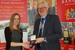 Claire Catherall receiving the Bronze Drapers' medal from Master Draper, Nicholas Bence-Trower