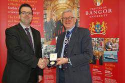 Stephen Clear (left) being awarded the Silver Drapers' medal from Master Draper, Nicholas Bence-Trower