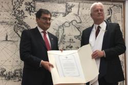 Dr Shaun Russell receiving an honorary doctoral certificate from Dr Jose Maripani (left) Vice Rector of the Universidad de Magallanes, Punta Arenas, Chile, at the investiture ceremony held recenty.