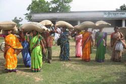 Women farmers taking away the certified seed bags of Ashoka 200F upland rice variety after a training session in Central Paraha Bhavan at Bero, Ranchi 