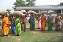 Women farmers taking away the certified seed bags of Ashoka 200F upland rice variety after a training session in Central Paraha Bhavan at Bero, Ranchi