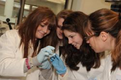 Delighted at extracting DNA in the lab as part of their Antarctica, Climate Change and Icefish project are left-right: Sara Hughes, Megan Caplin and Paige Bentley of Ysgol Bodedern, and Marie-Claude Dupuis of the Royal Society.
