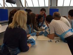 Participants paying close attention to Dr C Harker Rhodes during a practical session