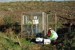 Collecting leachate from a capped landfill site