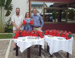 SENRGy’s Lars Markesteijn, Genevieve Lamond and James Walmsley with Deiniol dragons and other Bangor University alumni gifts during the event in Accra, Ghana. July 2017.